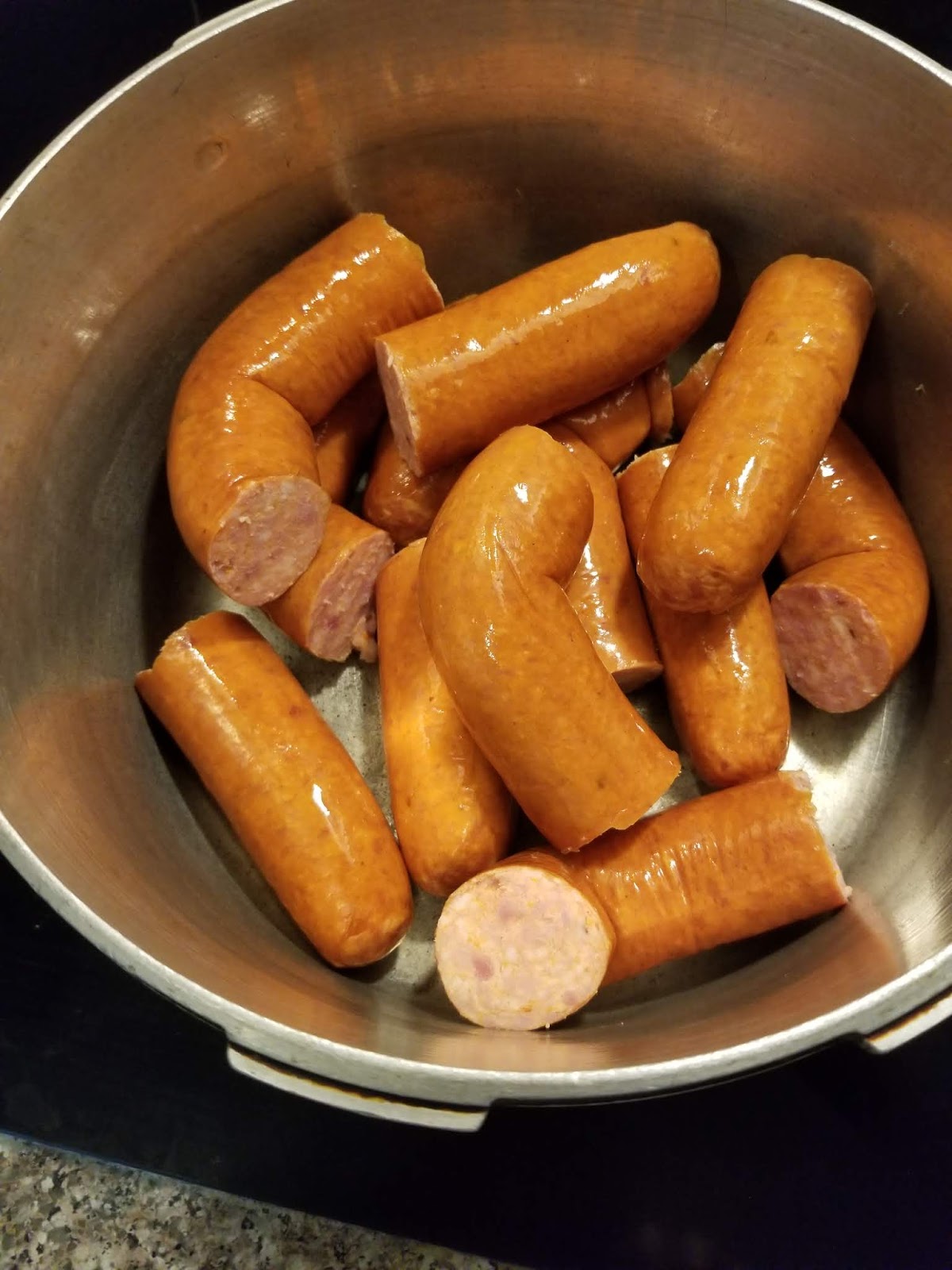 Cut rope sausage pieces in the pot, ready to boil