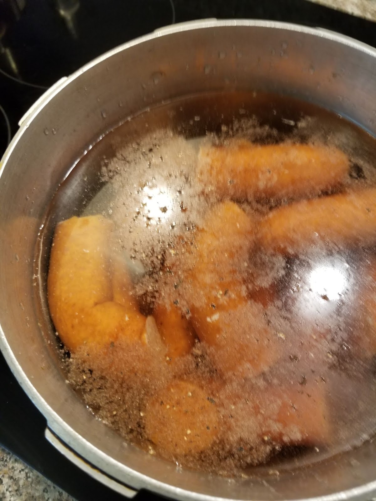 Sausage pieces simmering in seasoned water