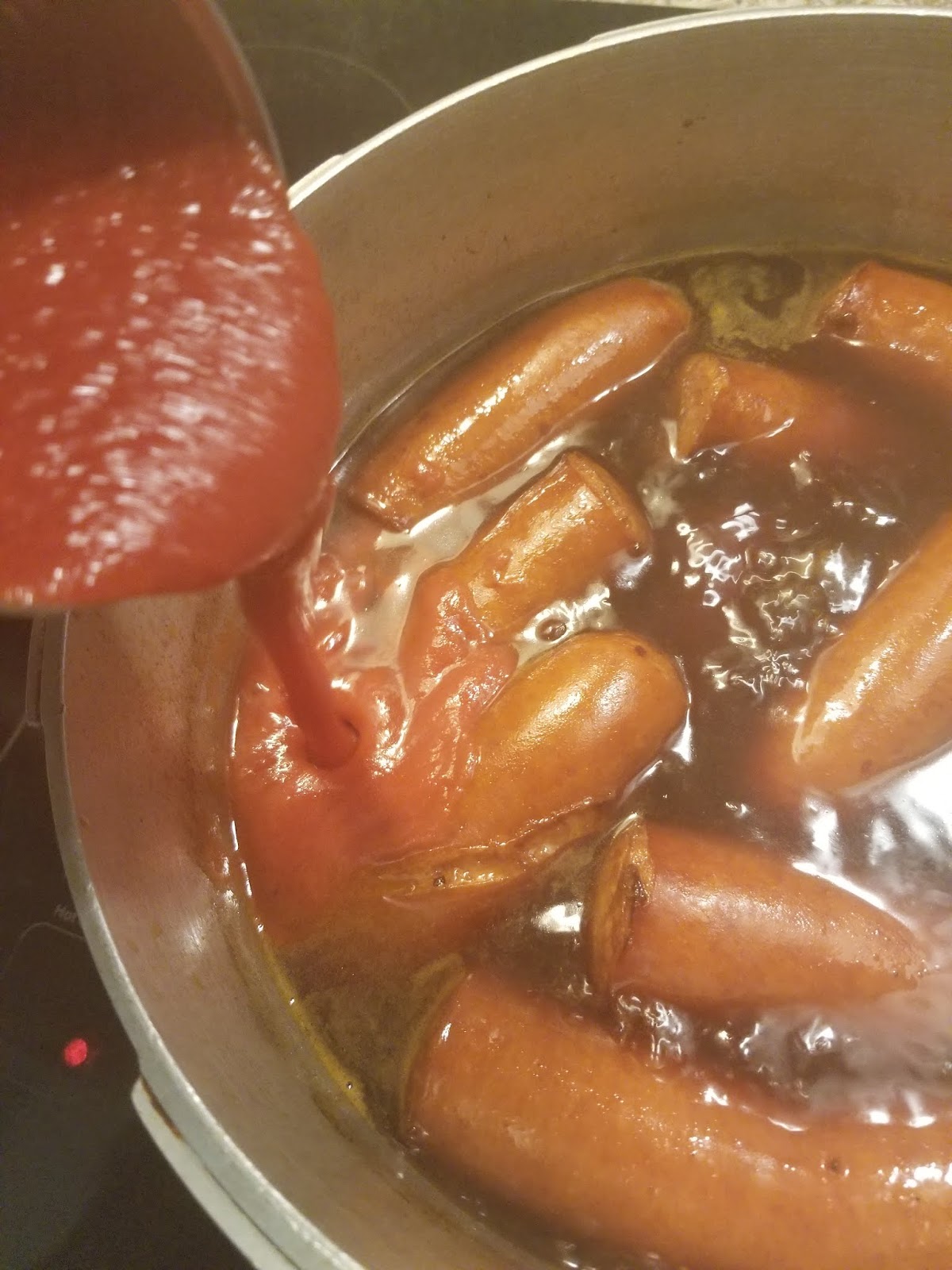 Tomato sauce stirred into pot